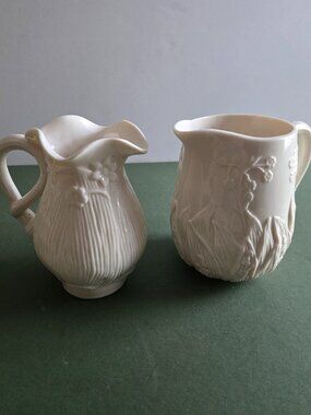 Pair of Ivory Bisque Pitchers